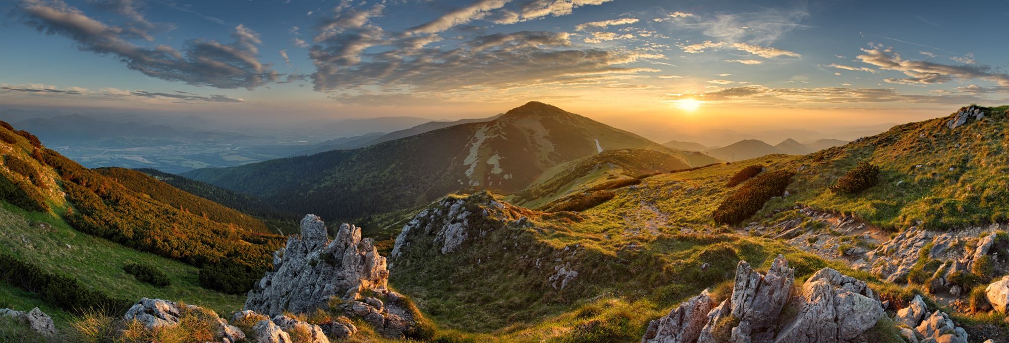 sun setting in the distance overlooking a mountain range